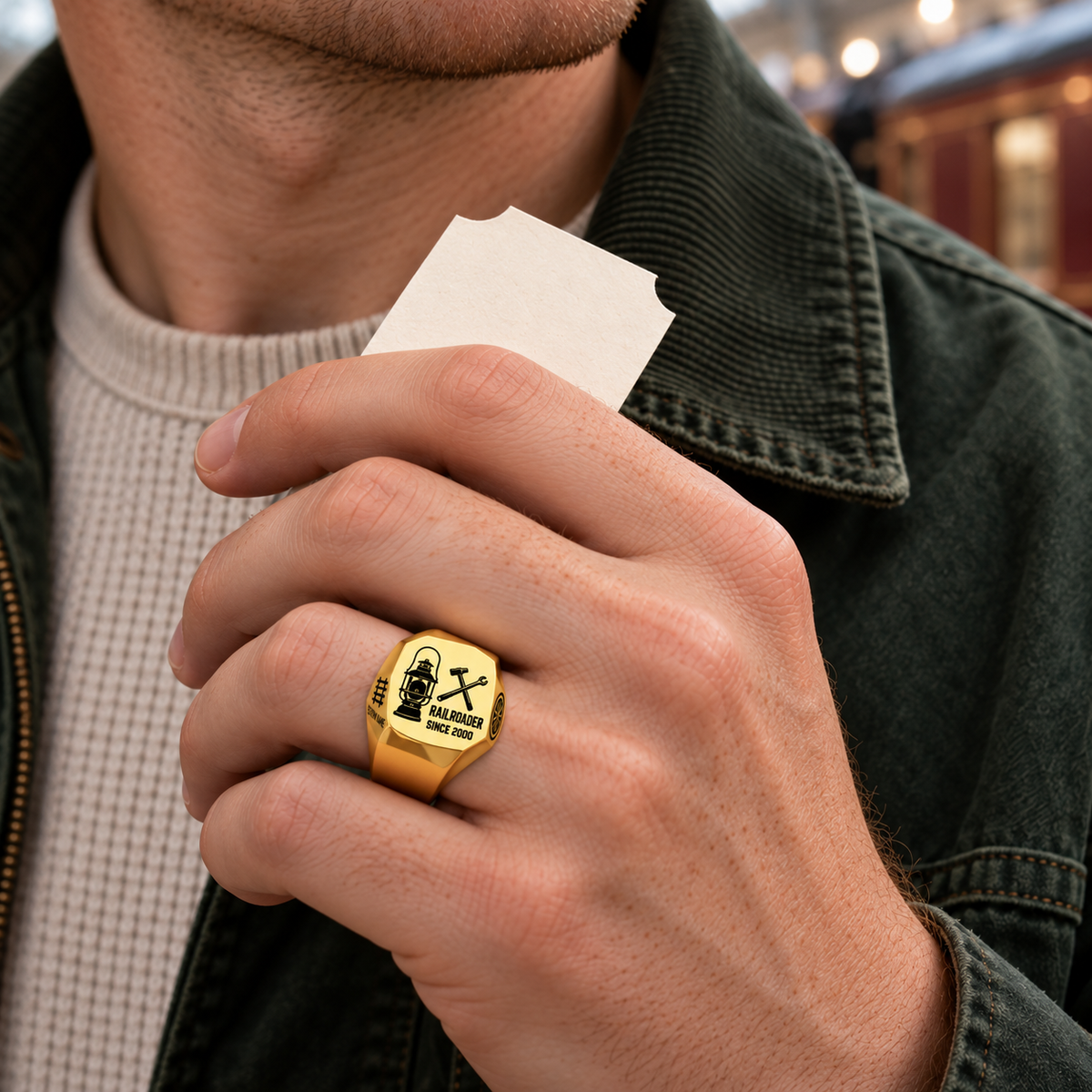 Gold Railroader Split Emblem ring worn in a safe off-duty railway-themed leisure setting