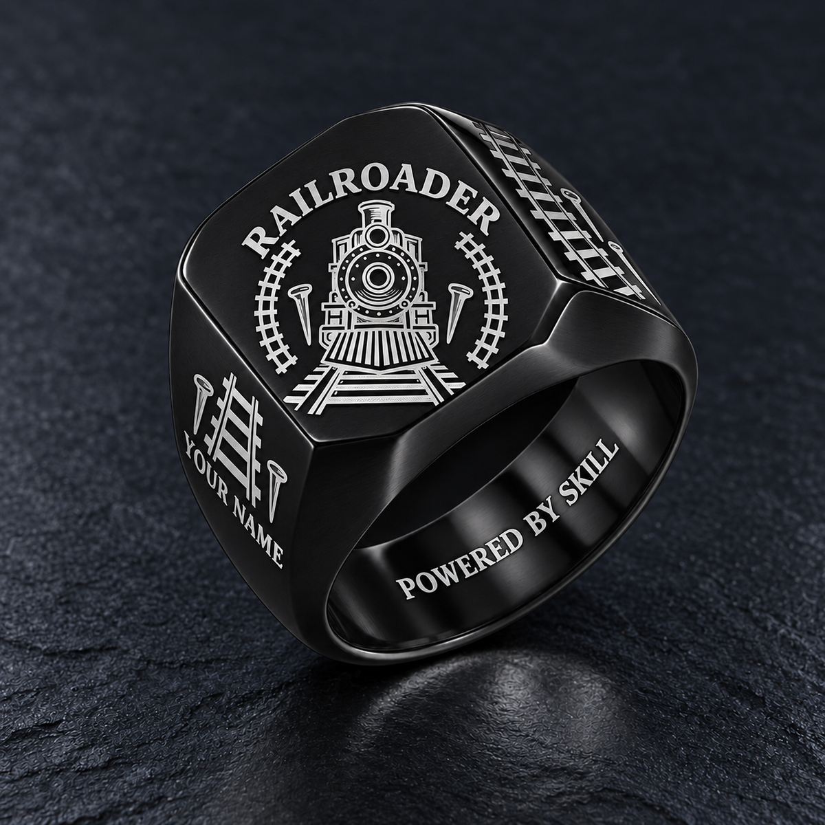 Black Railroader Classic Emblem ring with locomotive, track and railroad-spike artwork and illustrative YOUR NAME and POWERED BY SKILL