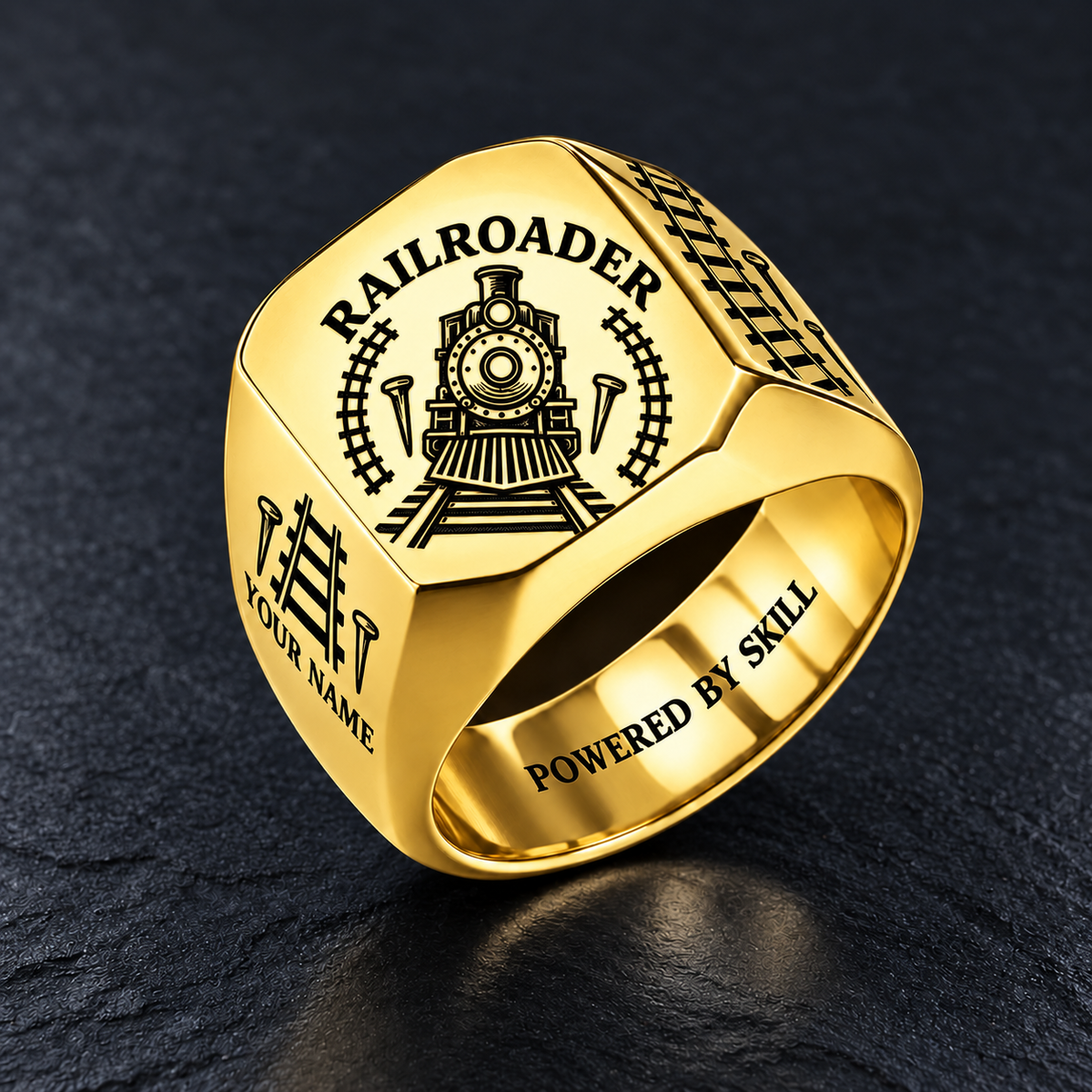 Gold Railroader Classic Emblem ring with locomotive, track and railroad-spike artwork and illustrative YOUR NAME and POWERED BY SKILL