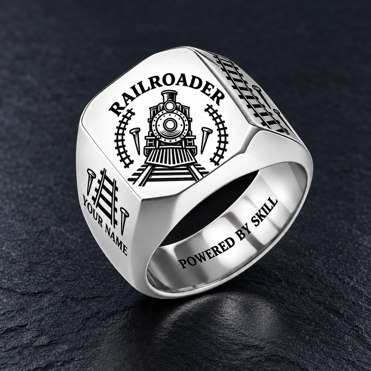 Silver Railroader Classic Emblem ring with locomotive, track and railroad-spike artwork and illustrative YOUR NAME and POWERED BY SKILL