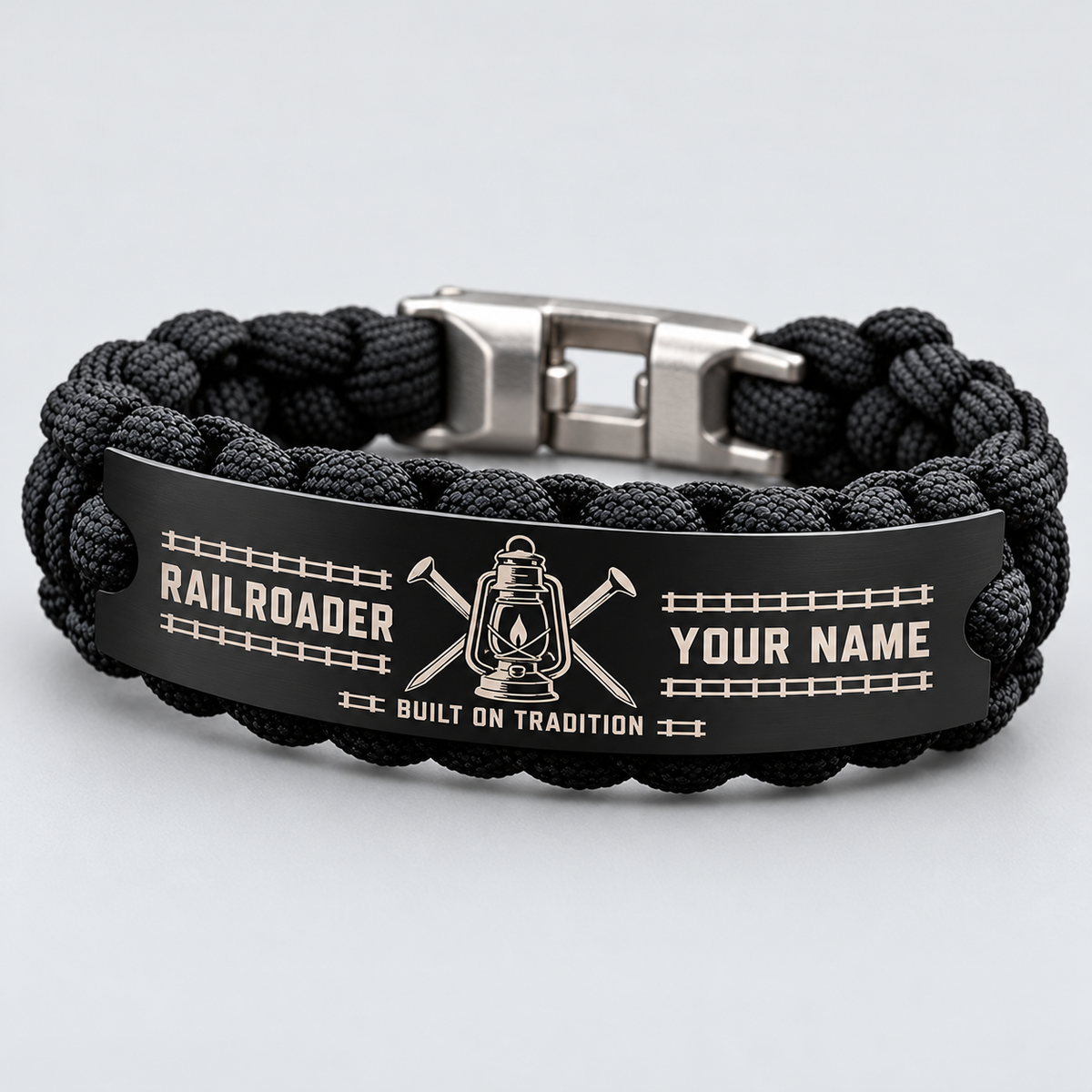 Standalone black Railroader bracelet with steel tag, visible silver shackle clasp, lantern and YOUR NAME preview