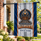 Railroader locomotive house flag hanging safely from a porch pole at a leafy brick home