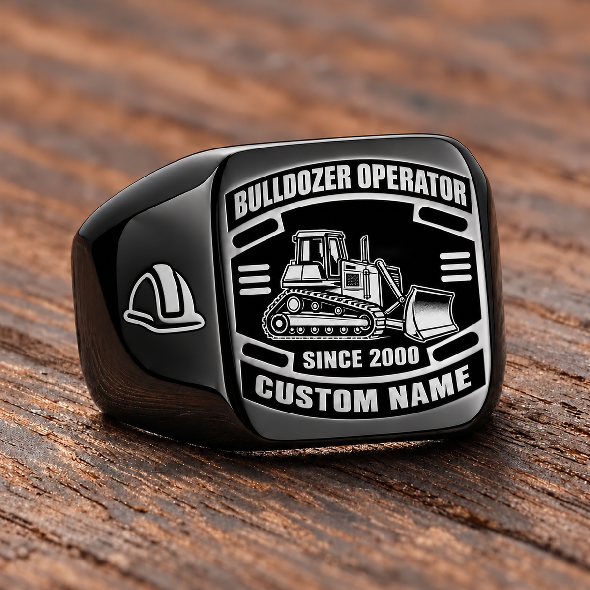 Black Bulldozer Operator Black Face Badge ring with a tracked bulldozer and front pushing blade on the black face, a hard-hat shoulder motif, and sample CUSTOM NAME and SINCE 2000 engraving.