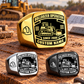 Gold-led triangular arrangement of Bulldozer Operator Black Face Badge rings in Gold, Silver and Black on a heavy-equipment maintenance workbench, with tracked bulldozer and hard-hat artwork and sample CUSTOM NAME and SINCE 2000 engraving.
