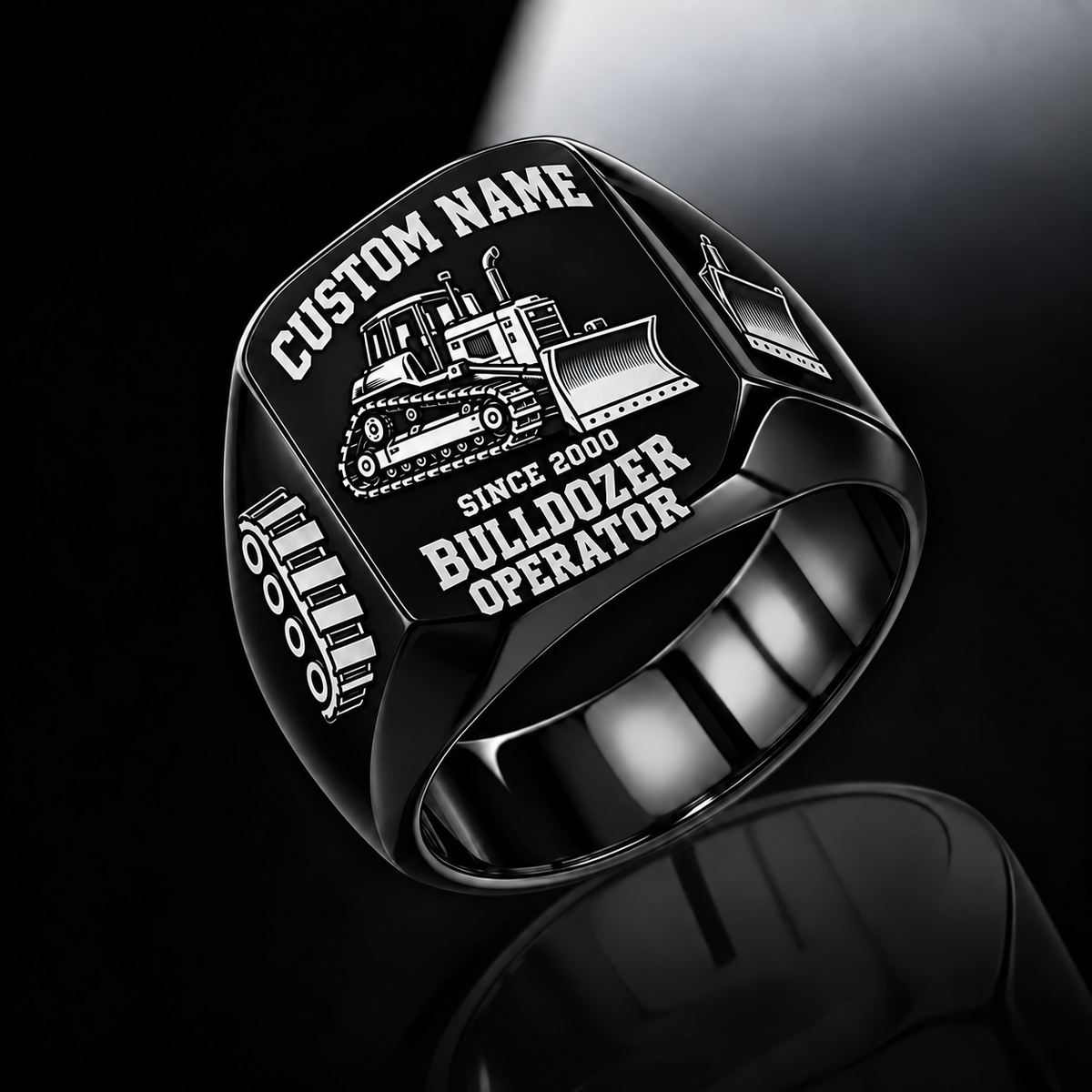 Black Bulldozer Operator Bold Lettering signet ring with a tracked bulldozer and pushing blade, track-link and blade shoulder motifs, a plain inner band, and sample CUSTOM NAME and SINCE 2000 engraving.
