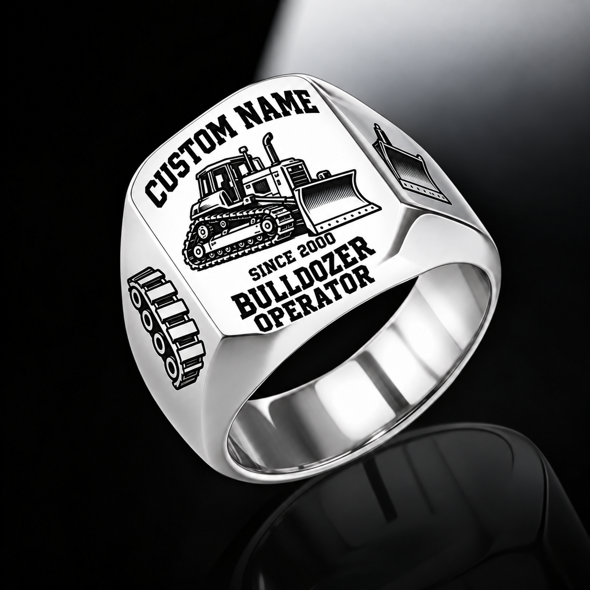 Silver Bulldozer Operator Bold Lettering signet ring with a tracked bulldozer and pushing blade, track-link and blade shoulder motifs, a plain inner band, and sample CUSTOM NAME and SINCE 2000 engraving.
