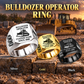 Bulldozer Operator Signature Crest ring in Silver, Gold and Black on a stepped stone display with a parked bulldozer in the background