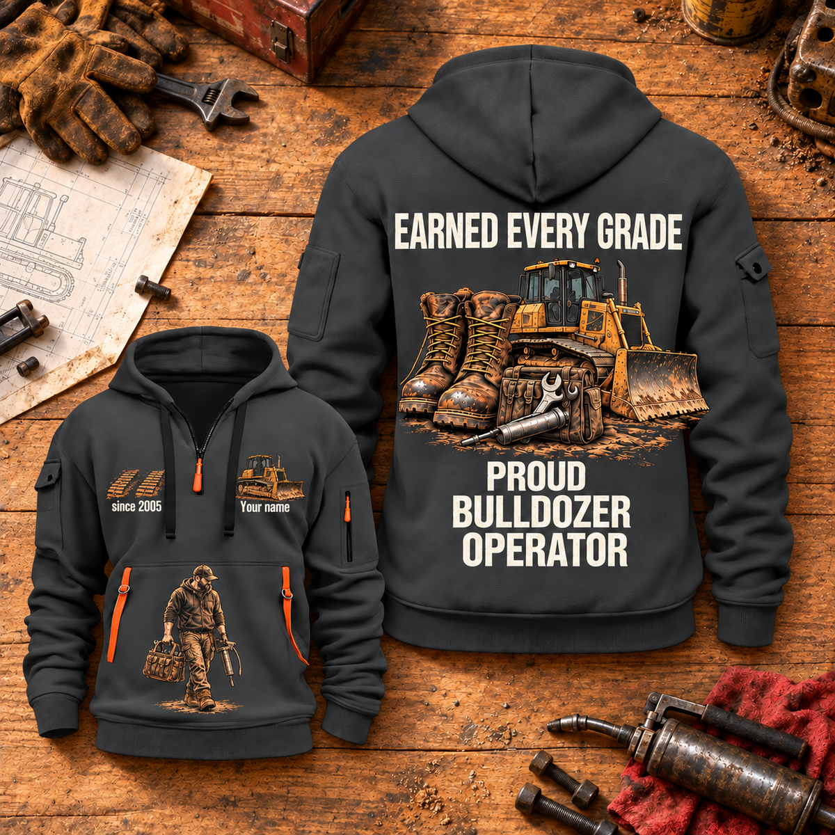 Bulldozer Operator Earned Every Grade Quarter-Zip Hoodie in Gray, dominant back and smaller front views on a maintenance workbench, with work boots, tracked bulldozer and maintenance-tool artwork