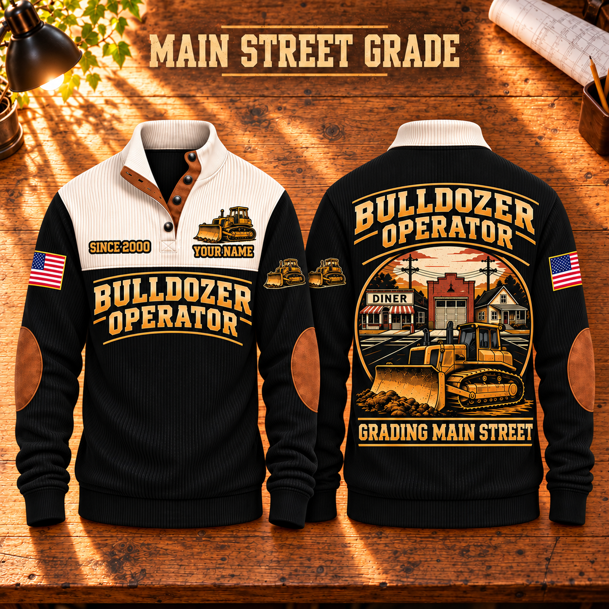 Bulldozer Operator Main Street Grade Sports Sweatshirt in Black, front and back views with tracked bulldozer artwork and Grading Main Street lettering on a warm wooden workbench