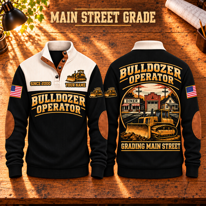 Bulldozer Operator Main Street Grade Sports Sweatshirt in Black, front and back views with tracked bulldozer artwork and Grading Main Street lettering on a warm wooden workbench