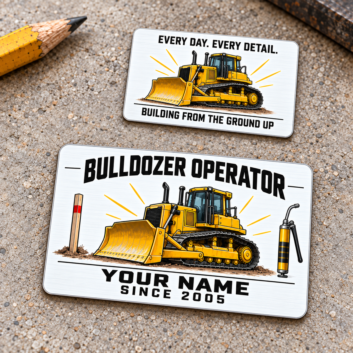 Front and reverse of the Bulldozer Operator Minimal Tool Grid aluminum wallet card on a pale workbench, showing a yellow tracked bulldozer, grade stake and grease gun with black lettering and a matching reverse.