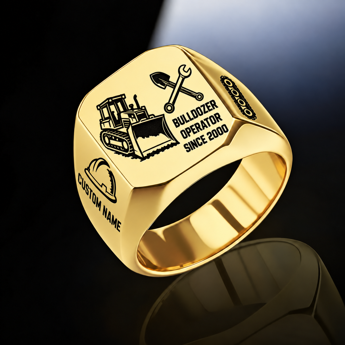 Gold Bulldozer Operator Split Emblem signet ring with a tracked bulldozer and pushing blade on the left, crossed shovel and wrench above occupation text on the right, hard-hat and track-chain shoulders, and sample CUSTOM NAME and SINCE 2000.