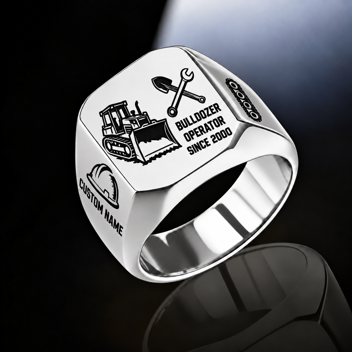 Silver Bulldozer Operator Split Emblem signet ring with a tracked bulldozer and pushing blade on the left, crossed shovel and wrench above occupation text on the right, hard-hat and track-chain shoulders, and sample CUSTOM NAME and SINCE 2000.