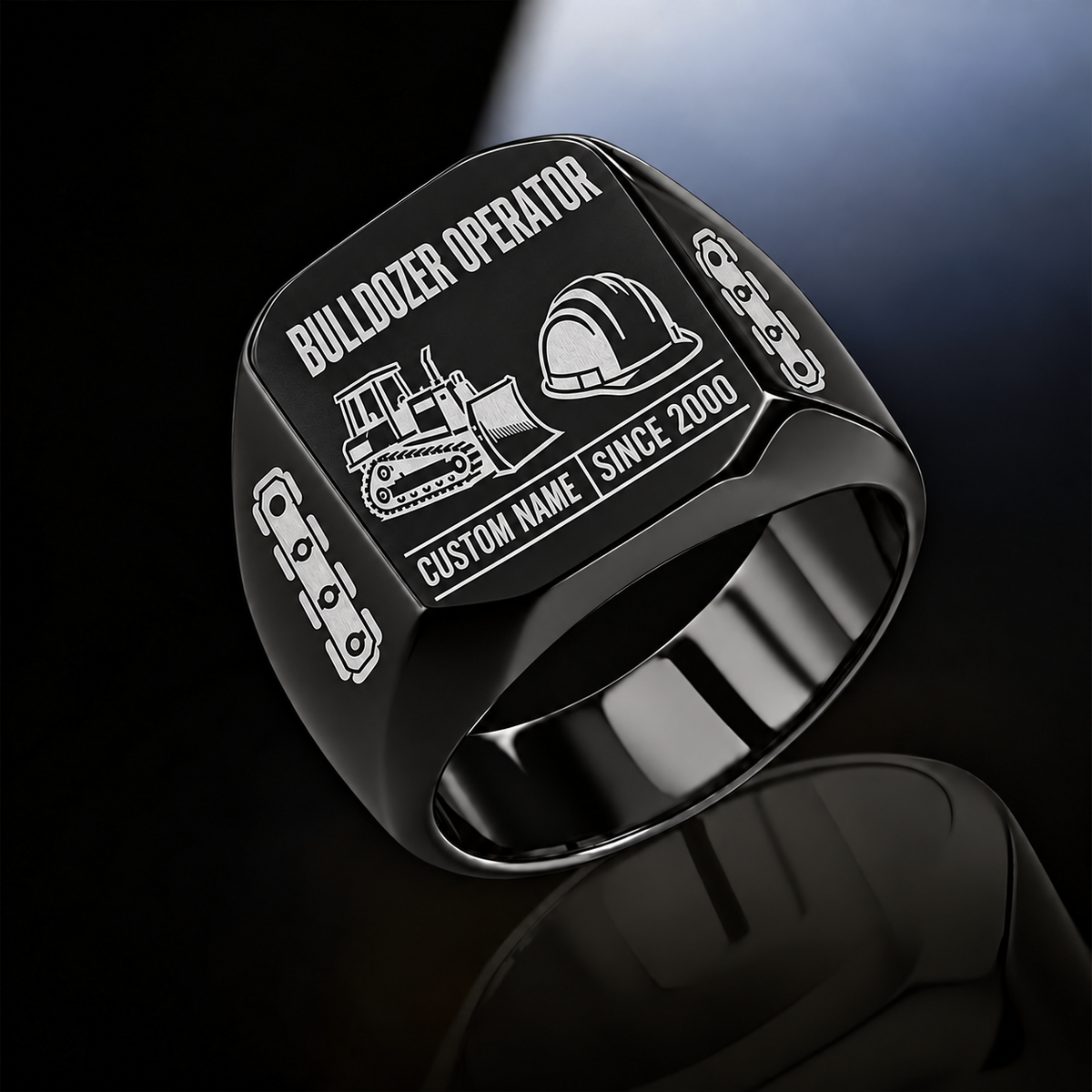 Black Bulldozer Operator Twin Icons signet ring with tracked bulldozer and hard-hat symbols, track-link shoulders, plain inner band, and sample CUSTOM NAME and SINCE 2000 engraving.