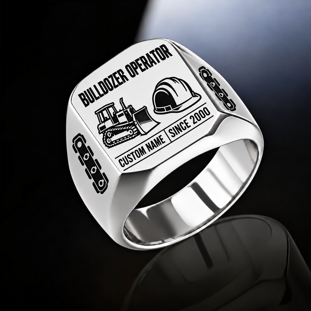 Silver Bulldozer Operator Twin Icons signet ring with tracked bulldozer and hard-hat symbols, track-link shoulders, plain inner band, and sample CUSTOM NAME and SINCE 2000 engraving.