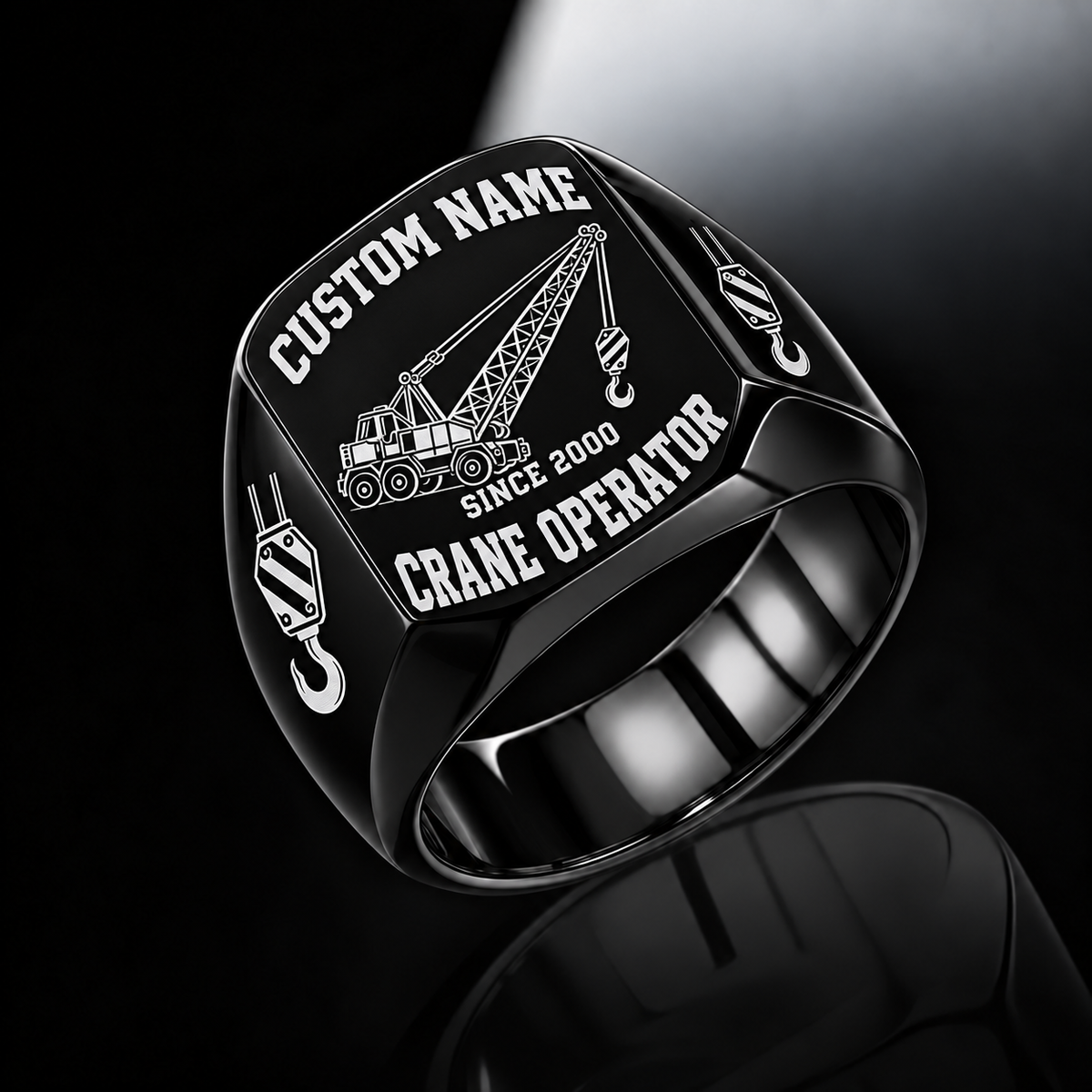 Black-finish Crane Operator Bold Lettering signet ring with lattice-boom crane and shoulder hoist-hook artwork, with illustrated CUSTOM NAME and SINCE 2000 text