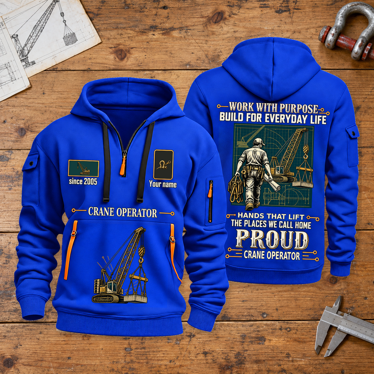 Crane Operator Built For The Everyday Quarter-Zip Hoodie in Blue, full authentic front and back views with matching crane operator tools and equipment artwork, original sample name/year and Built For The Everyday planning theme. On a crane operator workbench.