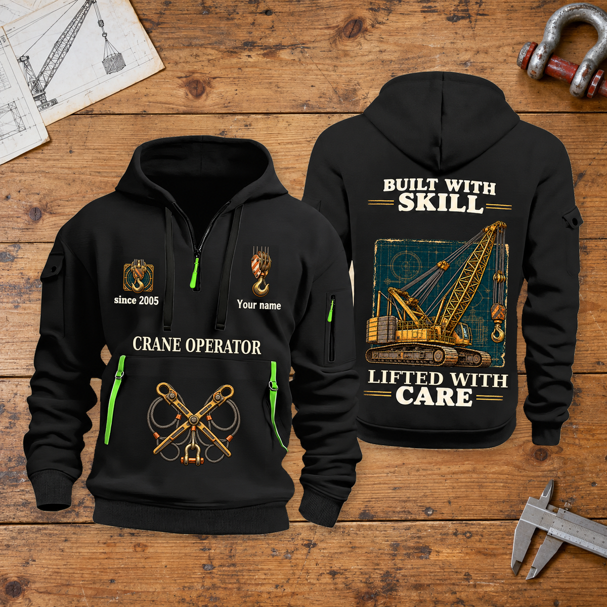 Crane Operator Built With Skill Quarter-Zip Hoodie in Black, full authentic front and back views with matching crane operator tools and equipment artwork, original sample name/year and Built With Skill slogan. On a crane operator workbench.