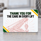 Reverse of the Crane Operator Green Band aluminum wallet card with Thank You for the Care in Every Lift lettering, a pale pink crane-and-rigging illustration, and green-and-yellow diagonal corner accents.