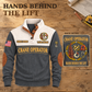 Grey Crane Operator Hands Behind the Lift Sports Sweatshirt, dominant front view with a back-print detail inset on a wooden workbench. Crane hook and rigging artwork, sample name and year, with the headline Hands Behind the Lift.
