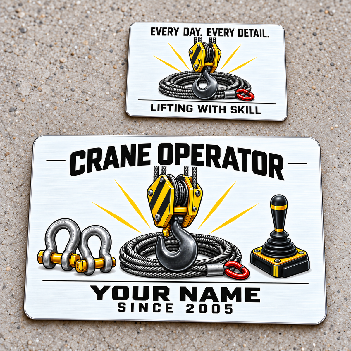 Front and reverse of the Crane Operator Minimal Tool Grid aluminum wallet card on pale concrete, with black lettering, a yellow crane hook block, steel wire rope, rigging shackles and a cab-control joystick; the reverse reads Every Day. Every Detail. and Lifting with Skill.