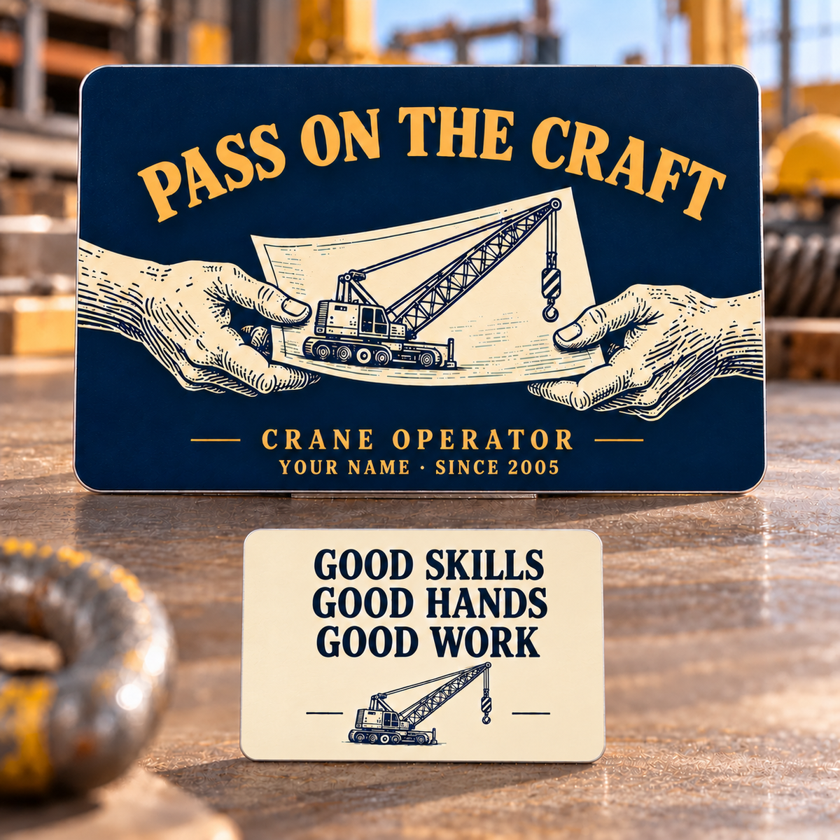 Front and reverse of the Crane Operator Pass on the Craft aluminum wallet card: engraved-style hands share a crane lift plan on midnight blue, with Good Skills, Good Hands, Good Work and a crane illustration on the cream reverse.