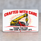 Reverse of the Crane Operator Red Header aluminum wallet card, with arched red Crafted with Care lettering, yellow crane and gray wire-rope artwork, and Thank You for the Care in Every Lift text framed by red decorative lines.