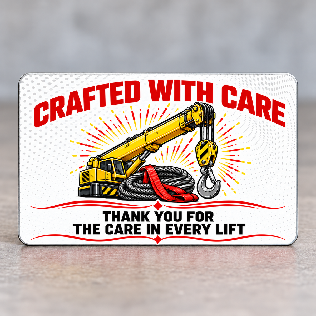 Reverse of the Crane Operator Red Header aluminum wallet card, with arched red Crafted with Care lettering, yellow crane and gray wire-rope artwork, and Thank You for the Care in Every Lift text framed by red decorative lines.