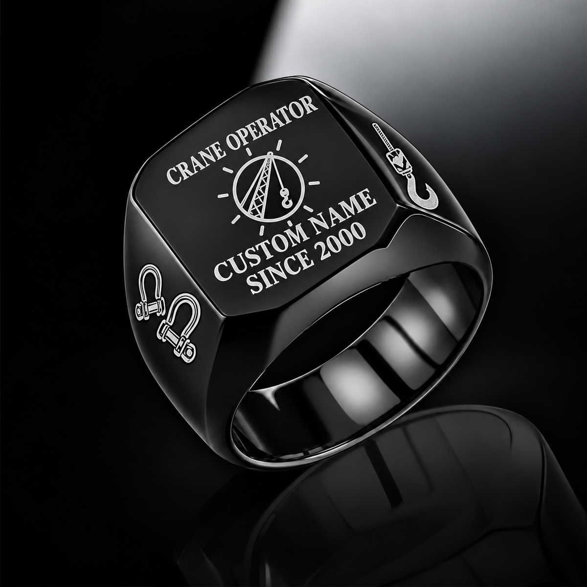 Black-finish Crane Operator Signature Crest signet ring with circular crane-hoist crest, shoulder shackles and lifting hook, and illustrated CUSTOM NAME and SINCE 2000 text