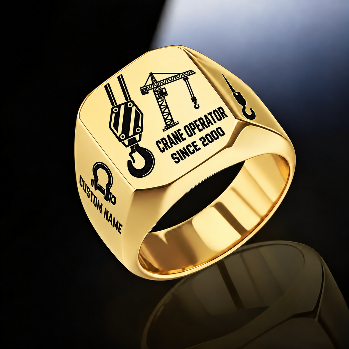 Gold-finish Crane Operator Split Emblem signet ring with split-face hoist hook and tower crane, plus bow-shackle and hook shoulder motifs and illustrated CUSTOM NAME and SINCE 2000 text