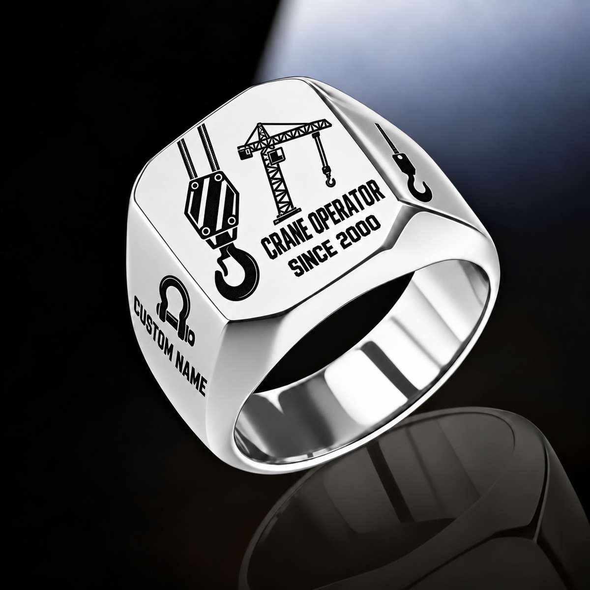 Silver-finish Crane Operator Split Emblem signet ring with split-face hoist hook and tower crane, plus bow-shackle and hook shoulder motifs and illustrated CUSTOM NAME and SINCE 2000 text