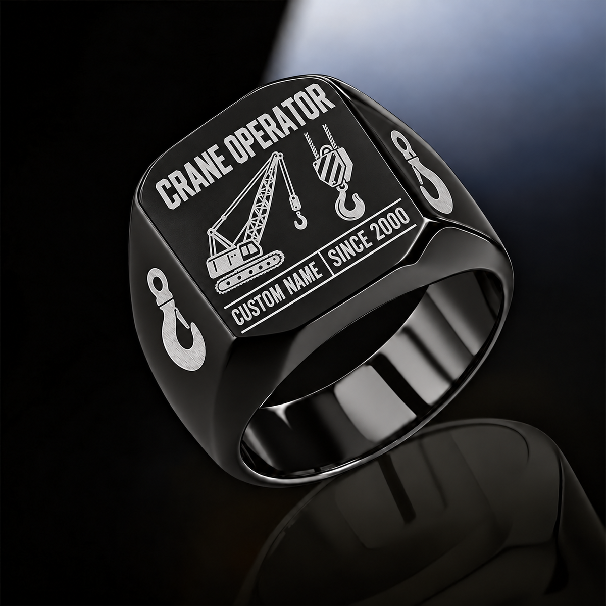 Black-finish Crane Operator Twin Icons signet ring with lattice-crane and hoist-hook emblems, shoulder hooks and illustrated CUSTOM NAME and SINCE 2000 text