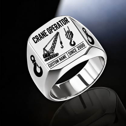 Silver-finish Crane Operator Twin Icons signet ring with lattice-crane and hoist-hook emblems, shoulder hooks and illustrated CUSTOM NAME and SINCE 2000 text