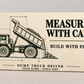 Front of the Dump Truck Driver Measure with Care aluminum wallet card, showing the rigid tipping-bed dump truck design and trade lettering.