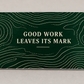 Reverse of the Dump Truck Driver Measure with Care aluminum wallet card, showing Good Work Leaves Its Mark over forest-green quarry contour artwork.