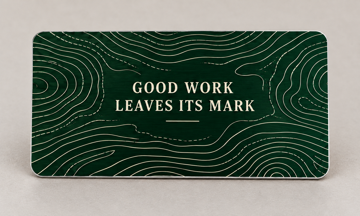 Reverse of the Dump Truck Driver Measure with Care aluminum wallet card, showing Good Work Leaves Its Mark over forest-green quarry contour artwork.