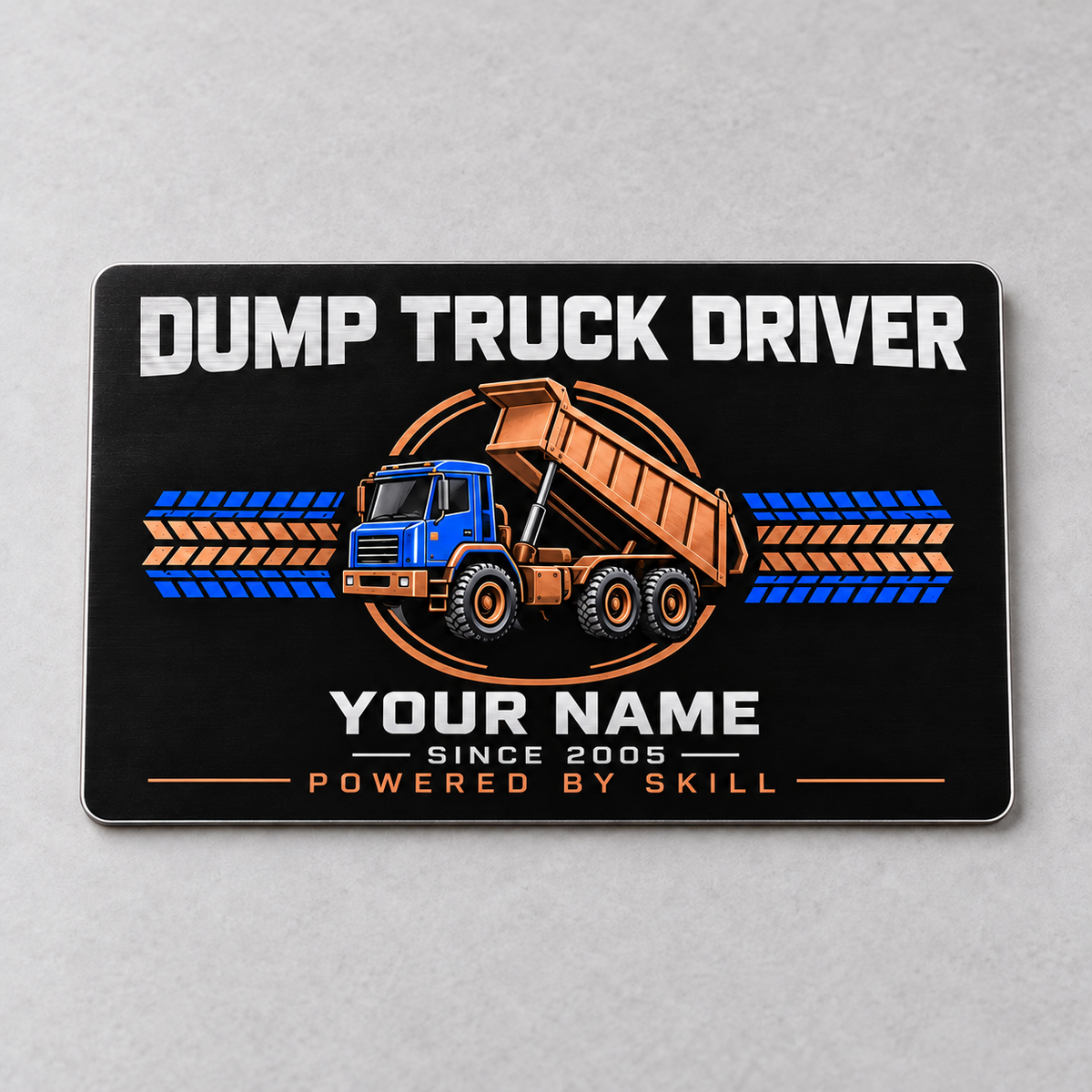 Front of the Dump Truck Driver Midnight Pride aluminum wallet card, showing the rigid tipping-bed dump truck design and trade lettering.