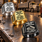Black-dominant diagonal display of Dump Truck Driver Craft Runs Deep rings in Silver, Gold and Black on a stationary truck-service workbench