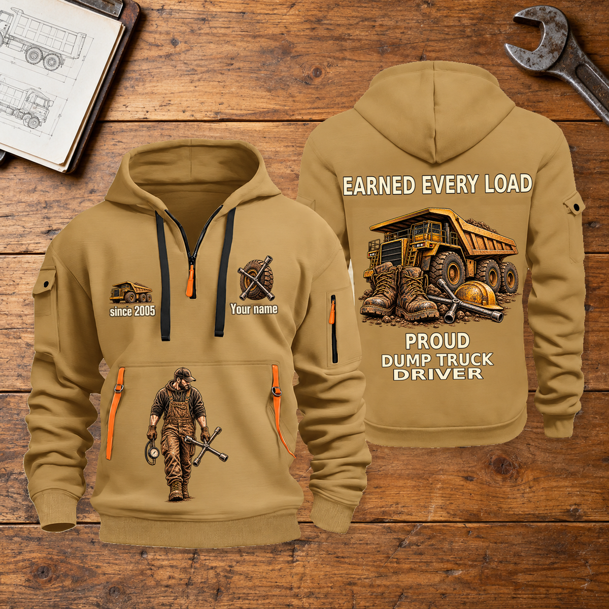 Dump Truck Driver Earned Every Load Quarter-Zip Hoodie in Khaki, full authentic front and back views with matching dump truck driver tools and equipment artwork, original sample name/year and Earned Every slogan. On a dump truck driver workbench.