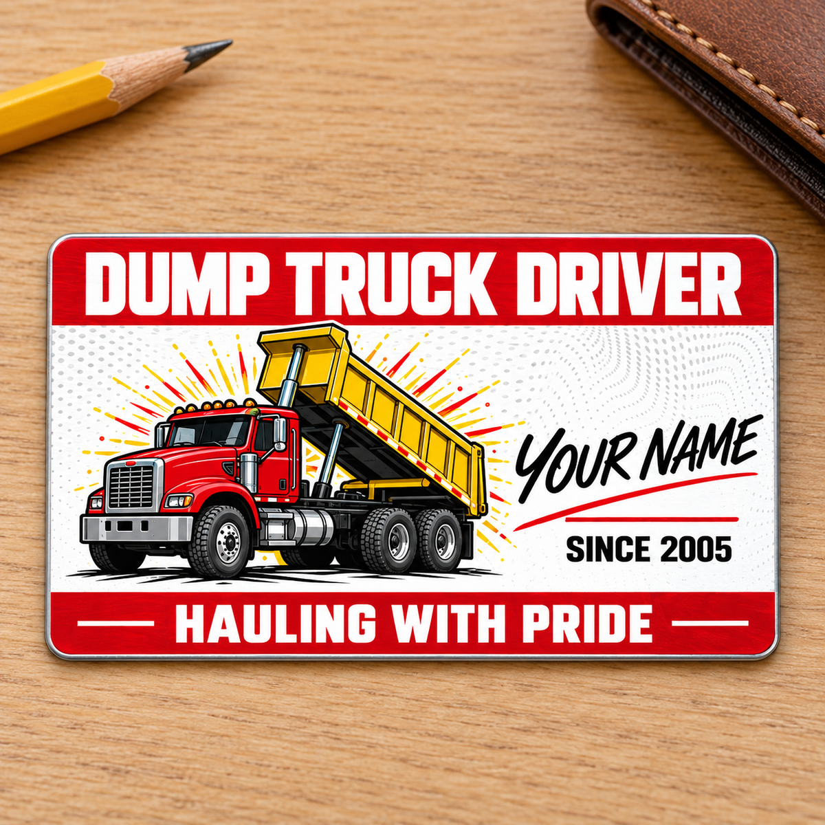 Dump Truck Driver Red Header Aluminum Wallet Card, showing the front on pale oak with a red-and-yellow rigid tipping-body dump truck and illustrative name/year lettering.