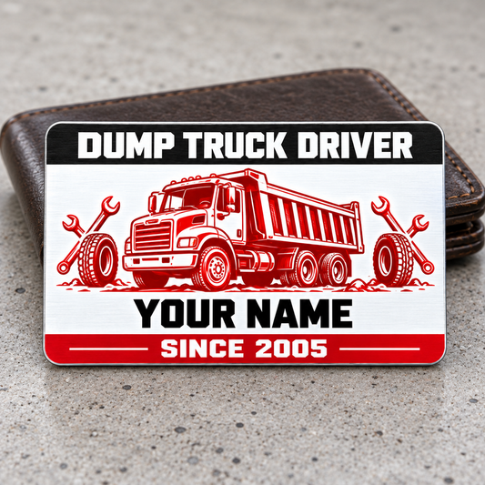 Dump Truck Driver Red Monochrome aluminum wallet card with a black header, red rigid dump-truck illustration, tire and wrench motifs, and sample name and year text, leaning against a closed wallet.