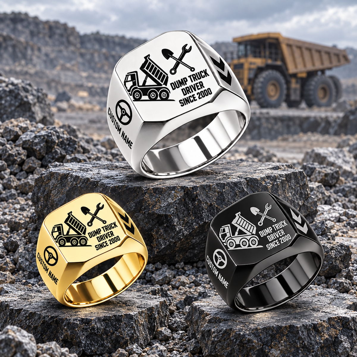Silver-led triangular display of Dump Truck Driver Split Emblem signet rings, with Gold at lower left and Black at lower right on quarry stone platforms