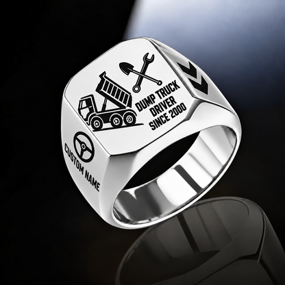 Silver-finish Dump Truck Driver Split Emblem signet ring with raised-bed dump truck, shovel and wrench artwork, and illustrated CUSTOM NAME and SINCE 2000 text