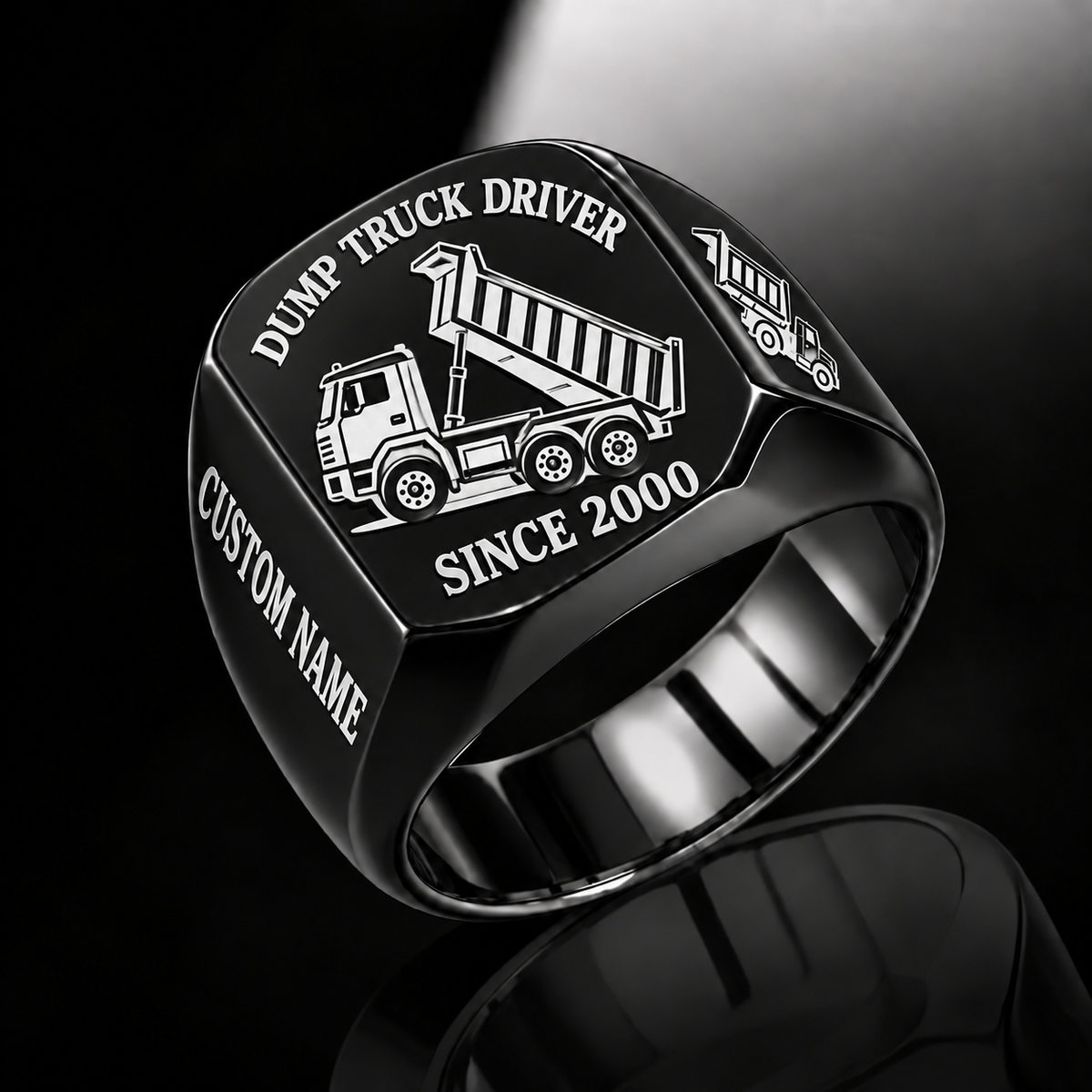 Black-finish Dump Truck Driver Trade Emblem signet ring with cab, wheels, high-sided tipping cargo bed and matching shoulder truck and illustrated CUSTOM NAME and SINCE 2000 text