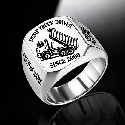 Silver-finish Dump Truck Driver Trade Emblem signet ring with cab, wheels, high-sided tipping cargo bed and matching shoulder truck and illustrated CUSTOM NAME and SINCE 2000 text