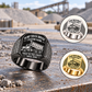 Black Dump Truck Driver True to the Craft ring on a gravel-haul depot desk, with smaller Silver and Gold ring insets at right