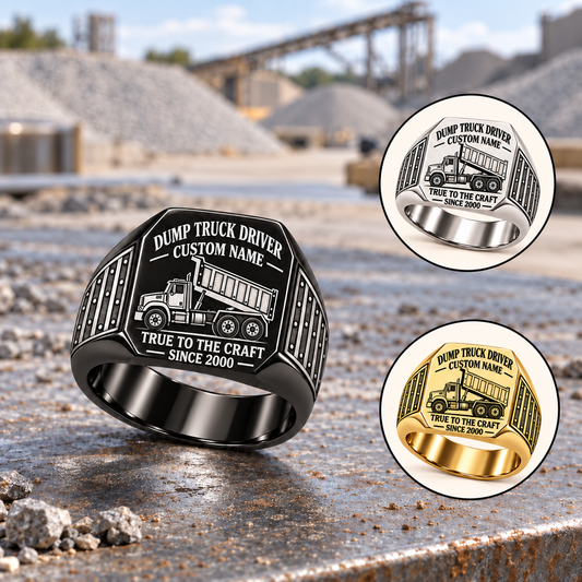 Black Dump Truck Driver True to the Craft ring on a gravel-haul depot desk, with smaller Silver and Gold ring insets at right