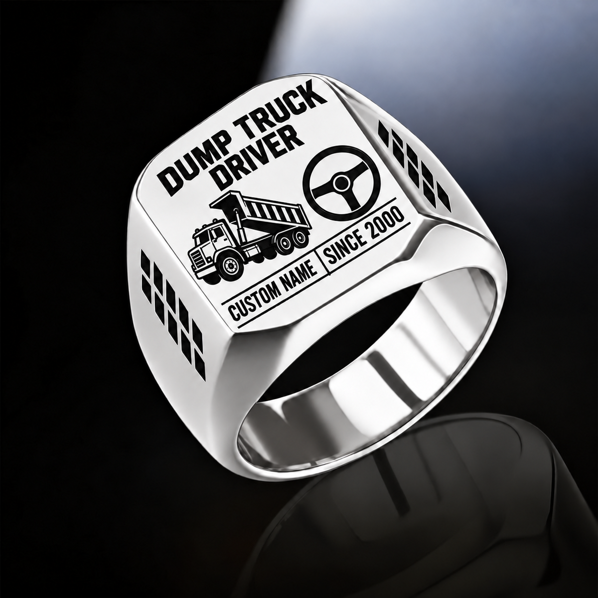 Silver-finish Dump Truck Driver Twin Icons signet ring with raised-bed dump truck and steering wheel icons, tire-tread shoulders, and illustrated CUSTOM NAME and SINCE 2000 text
