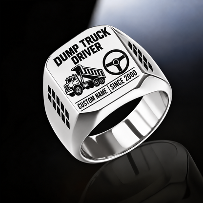 Silver-finish Dump Truck Driver Twin Icons signet ring with raised-bed dump truck and steering wheel icons, tire-tread shoulders, and illustrated CUSTOM NAME and SINCE 2000 text