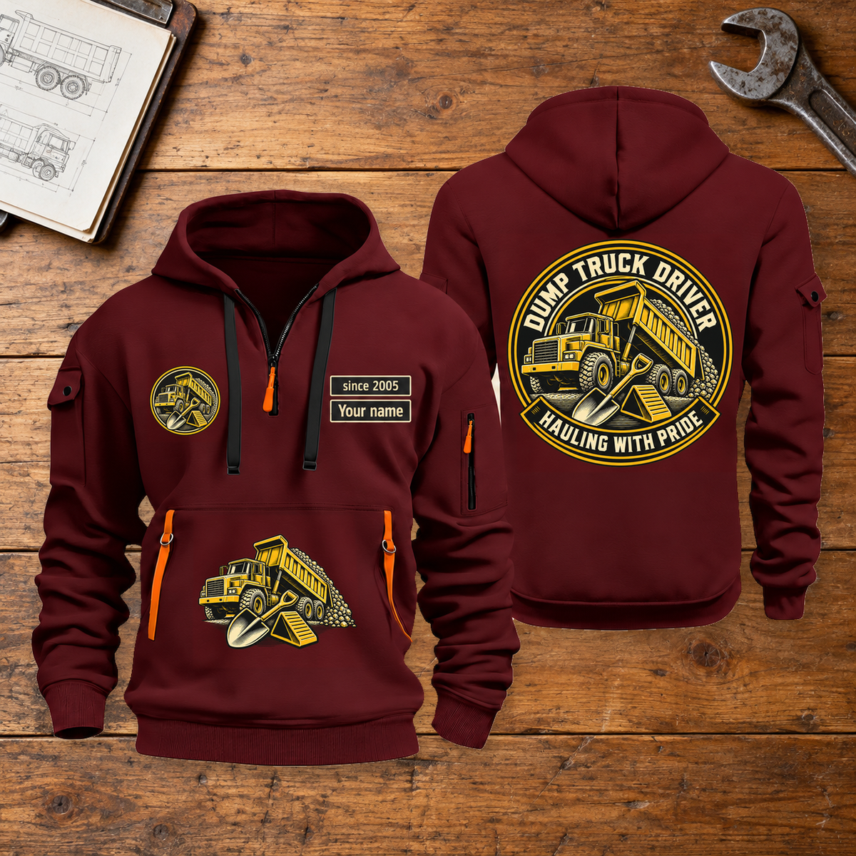 Dump Truck Driver Hauling With Pride Quarter-Zip Hoodie in Wine Red, full authentic front and back views with matching dump truck driver tools and equipment artwork, original sample name/year and trade-pride badge lettering. On a dump truck driver workbench.